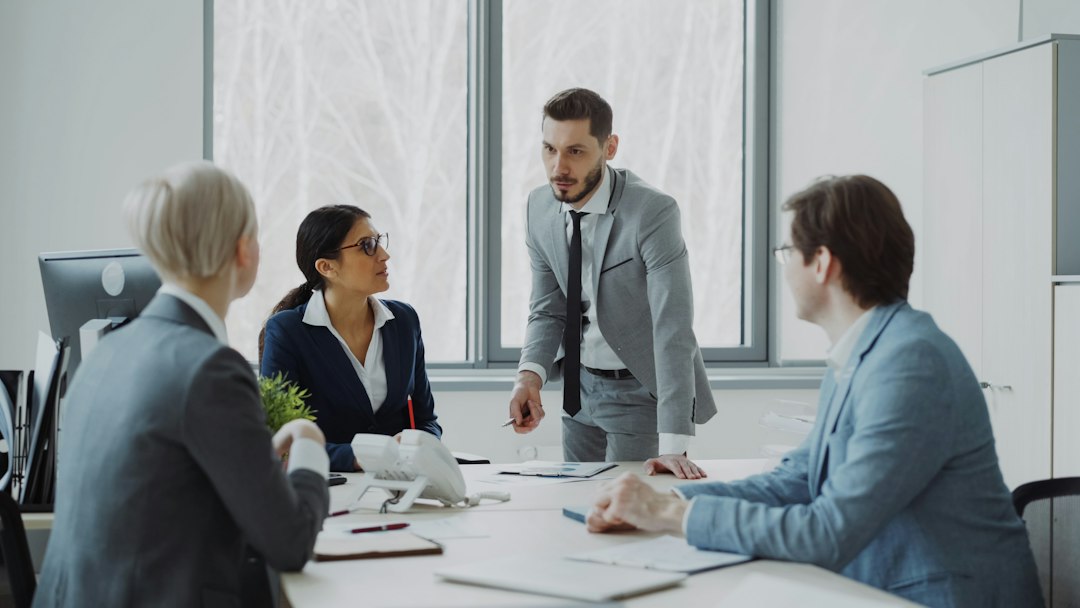 Leader discussing a presentation with colleagues in a modern meeting room